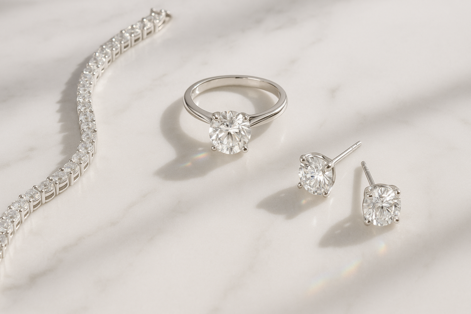 Silver jewelry set with necklace, ring, and earrings on a light background